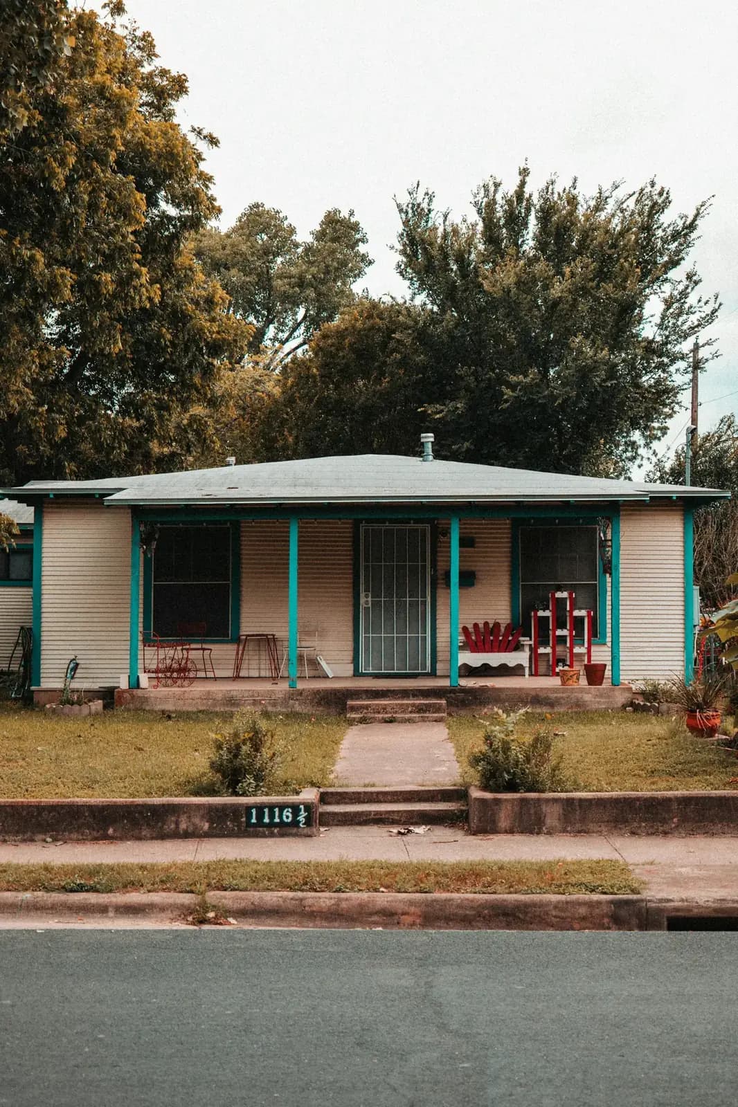 A modest Austin bungalow with a deep front porch and turquoise posts