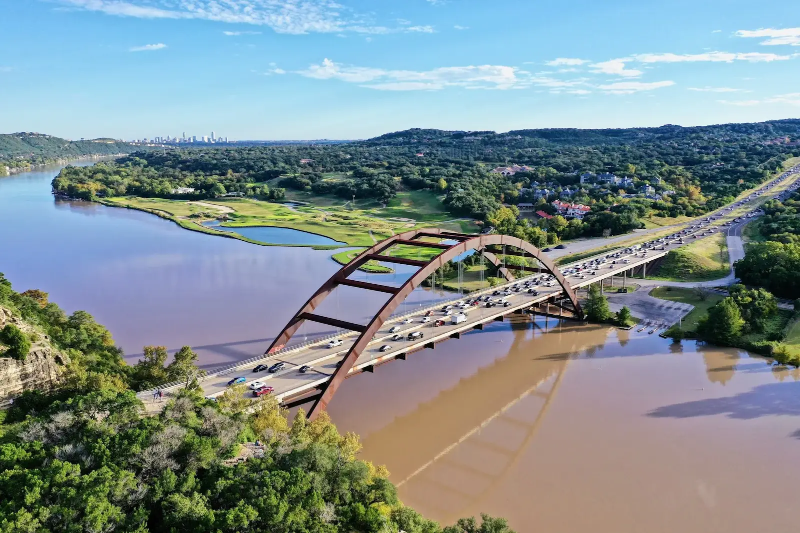 Pennybacker Bridge crossing Lake Austin among wooded hills