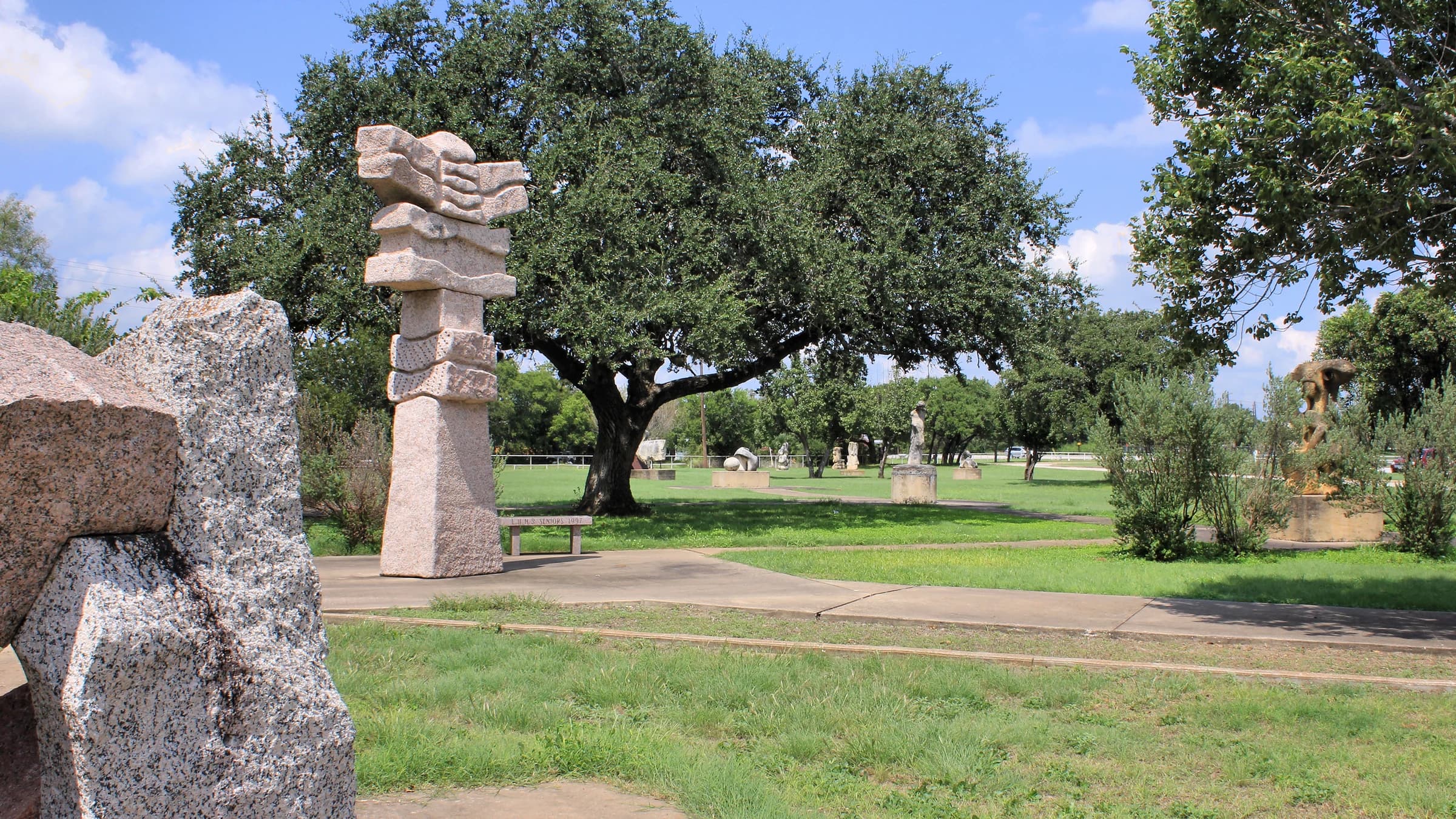 Granite sculptures under live oaks at the Liberty Hill International Sculpture Park, in the town whose address Santa Rita Ranch carries